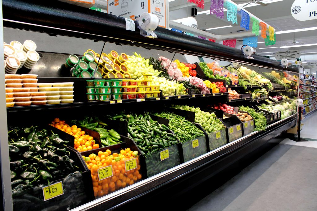 Produce section at our deli shows a variety of vegetables in a cooler.