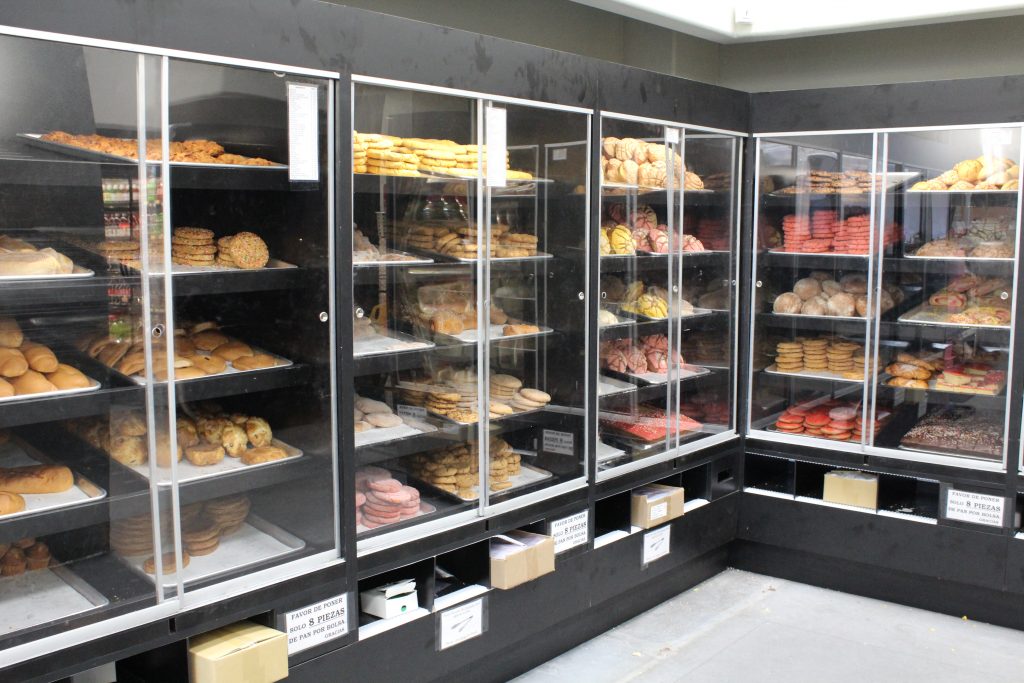 A view inside the bakery shows cases with baked goods